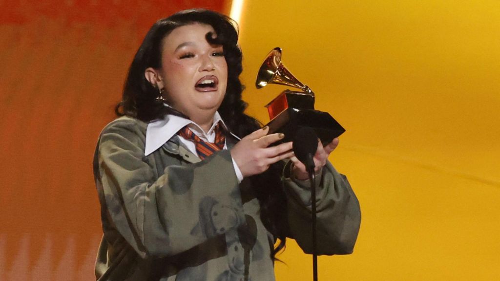Lola Young looking overwhelmed and holding her Grammy on stage