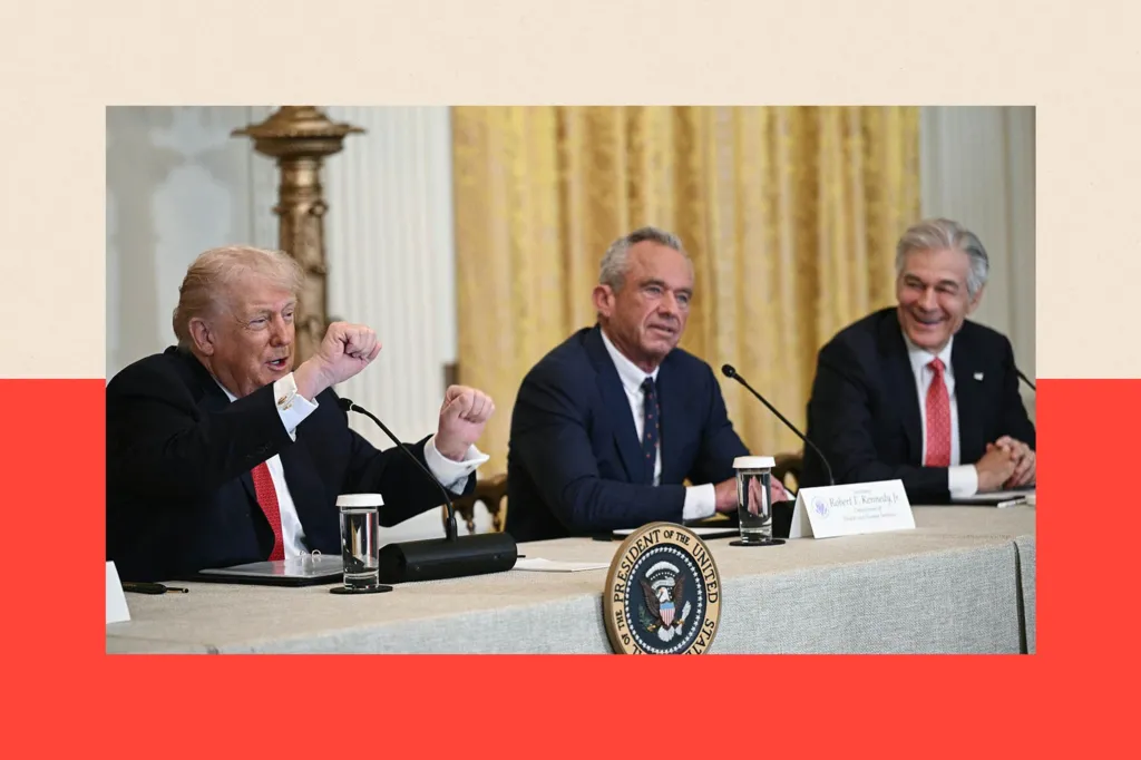 Donald Trump, Robert F Kennedy Jr and Mehmet Oz sit behind a table bearing the presidential seal