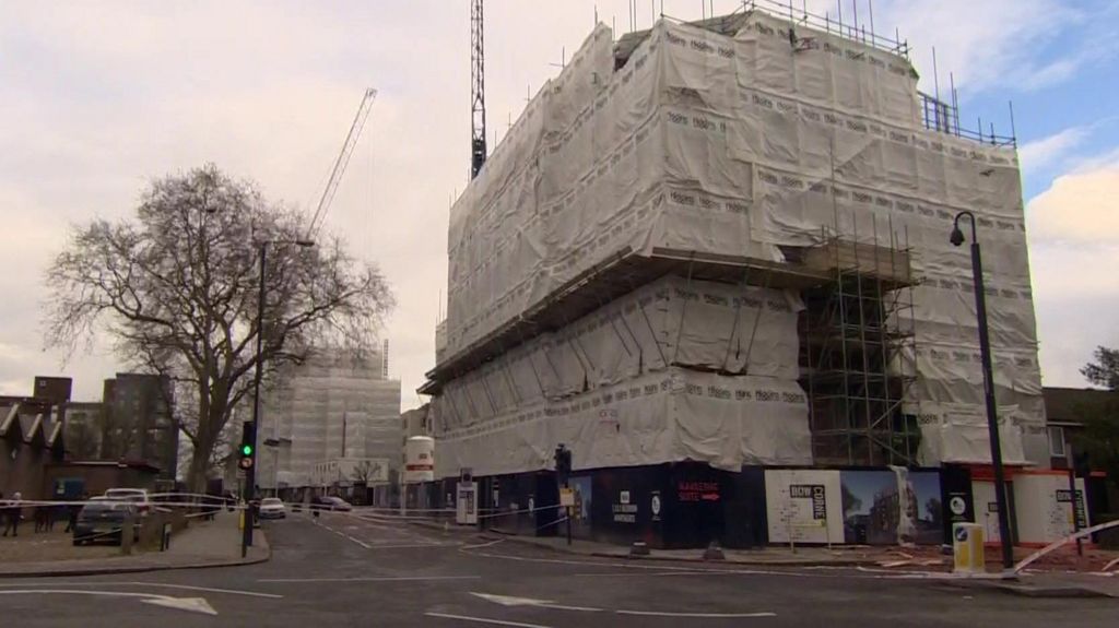 Two large buildings covered in tarpaulin and scaffolding - the building site where the accident happened.