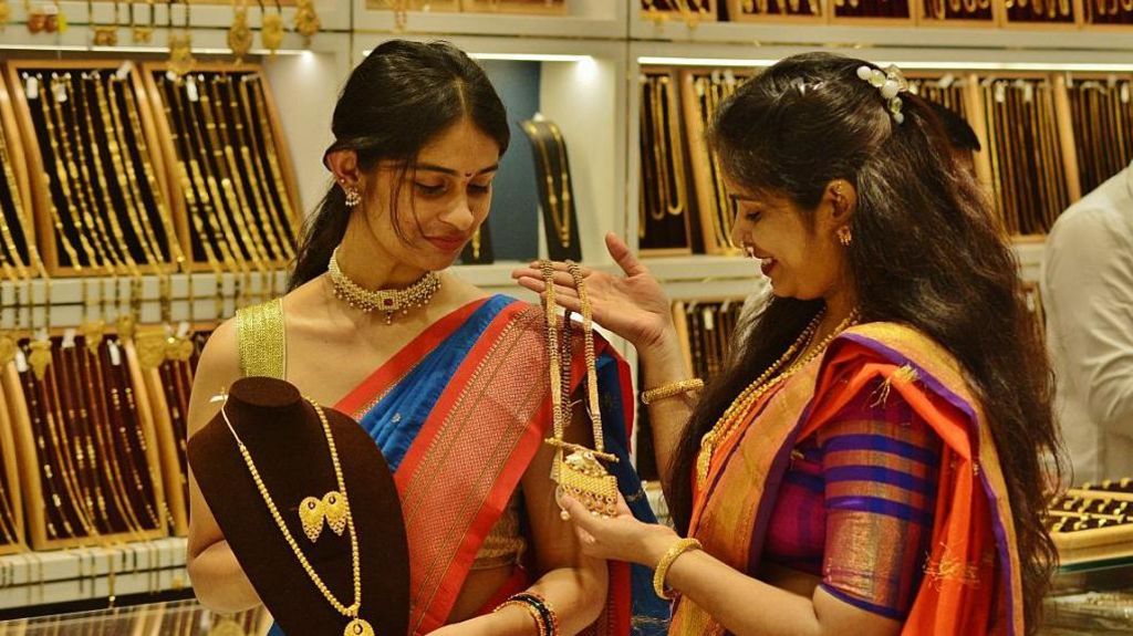 Two women looking at gold on display at a gold jewellery store