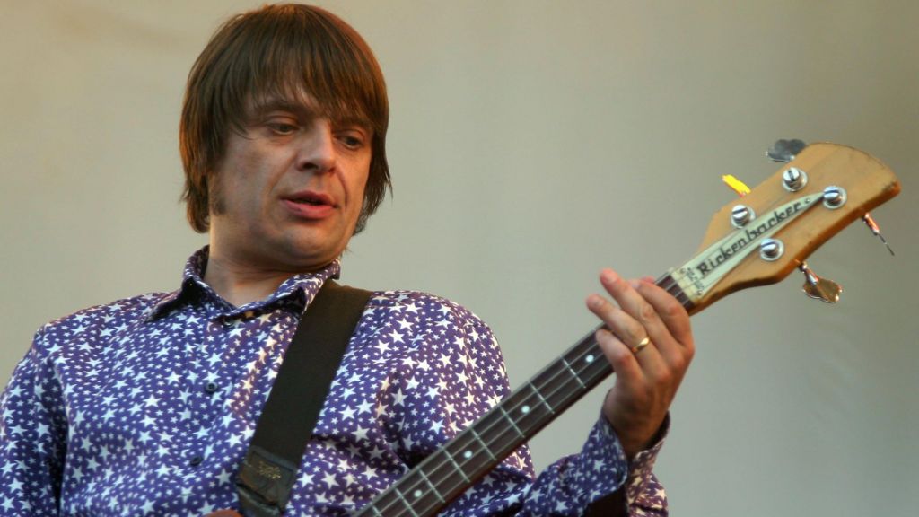 Gary 'Mani' Mounfield of Primal Scream performs on stage on the second day of the annual Nokia Isle Of Wight Festival at Seaclose Park on June 10, 2006 in Newport, England