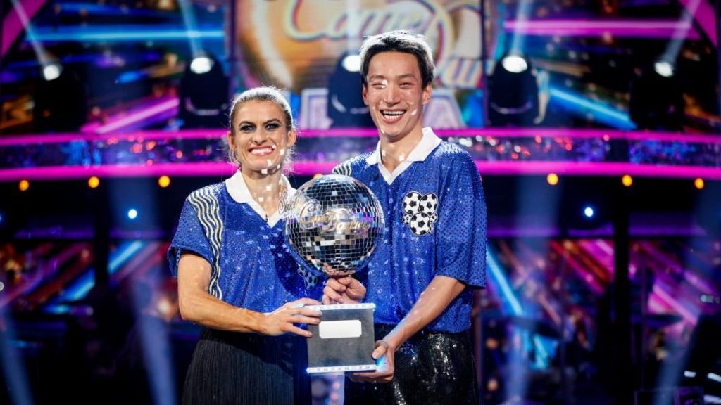 Karen Carney and Carlos Gu with their trophy after winning the 2025 series of Strictly Come Dancing.