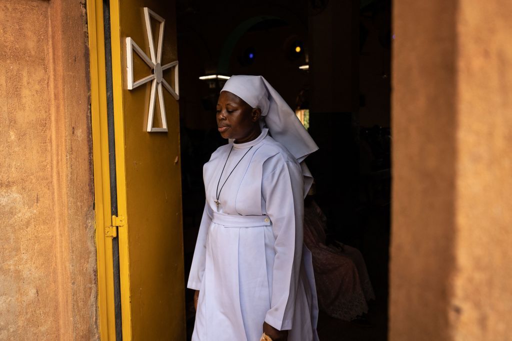 A nun walks out of Ouagadougou cathedral on June 12, 2022.