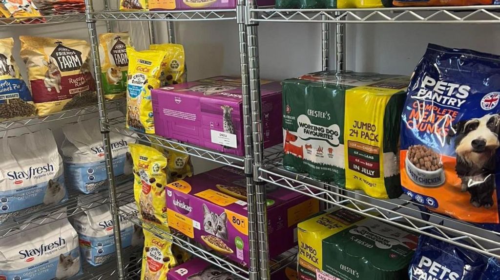 An image of various pet food on wire shelves 