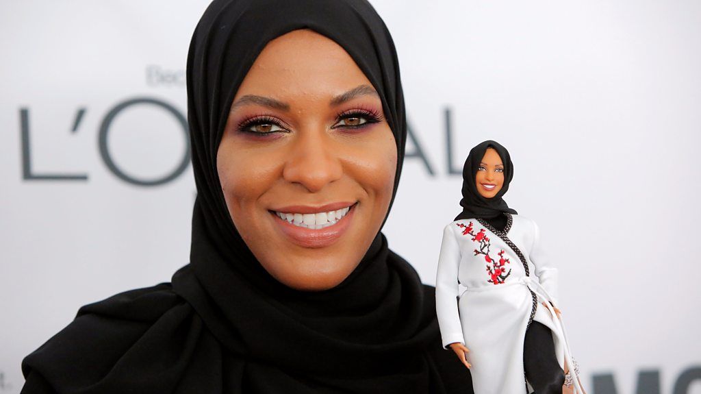 Ibtihaj Muhammad holds a Barbie.