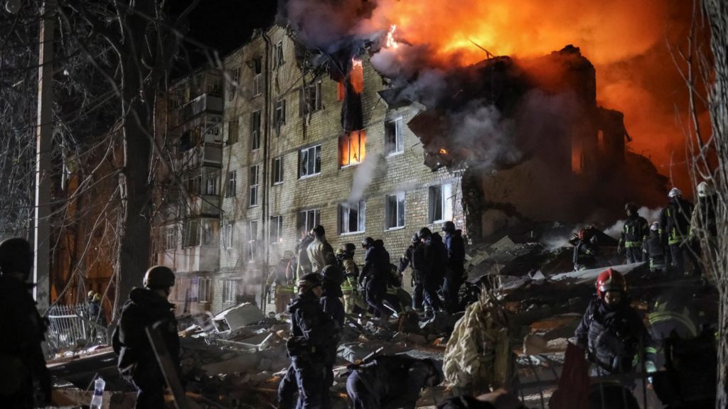 Rescuers work at the site of a Russian missile strike on an apartment building in Kharkiv, Ukraine