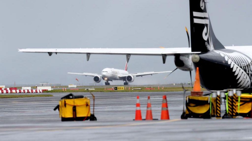 An Emirates plane touches down at Auckland International Airport