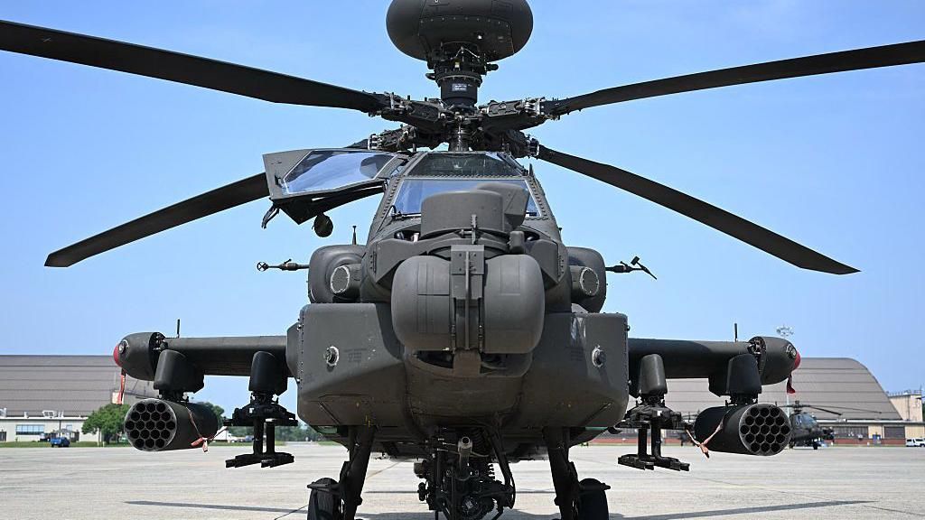 File image of an AH-64 Apache helicopter in a stationary position ahead of a US military parade