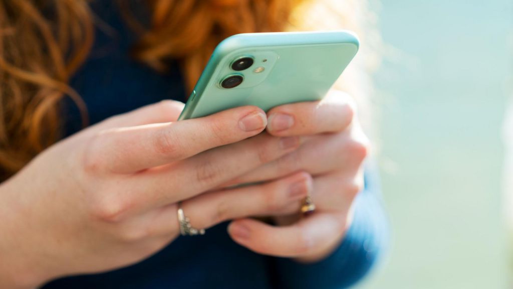 A woman holding a mobile phone