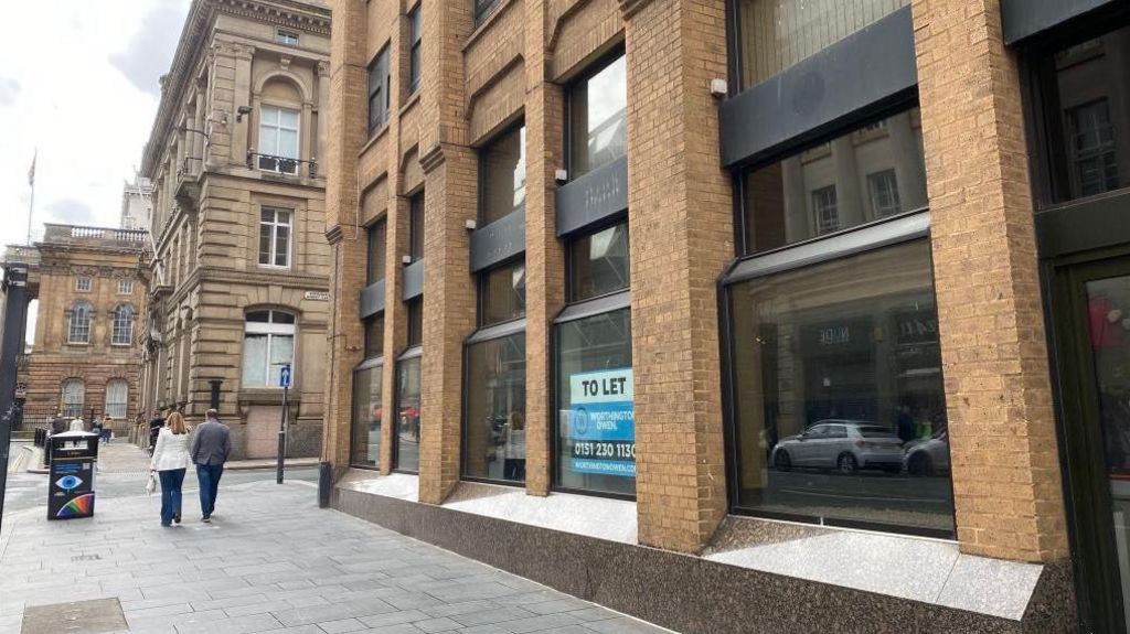 The exterior of Imperial Buildings, 9 Dale Street, in Liverpool. It is a modern office building of brick and glass, and Liverpool Town Hall can be seen in the background of the photograph. 