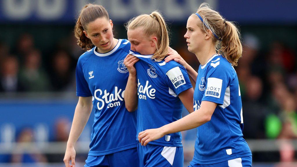 Aggie Beever-Jones is supported by her Everton team-mates
