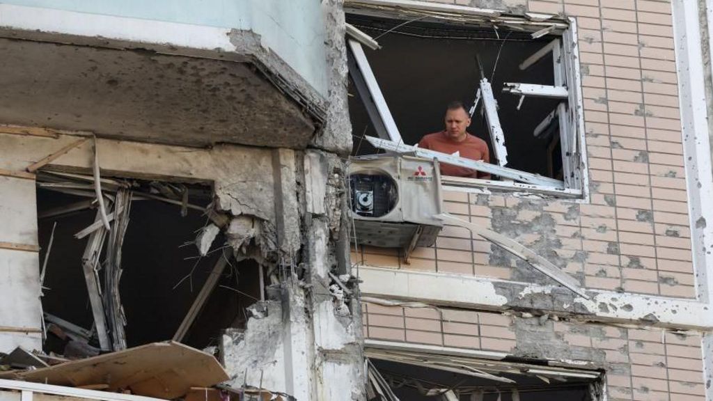 A man inspects a damaged apartment building following a Ukrainian drone attack in the Moscow region, Russia. Photo: 17 May 2026