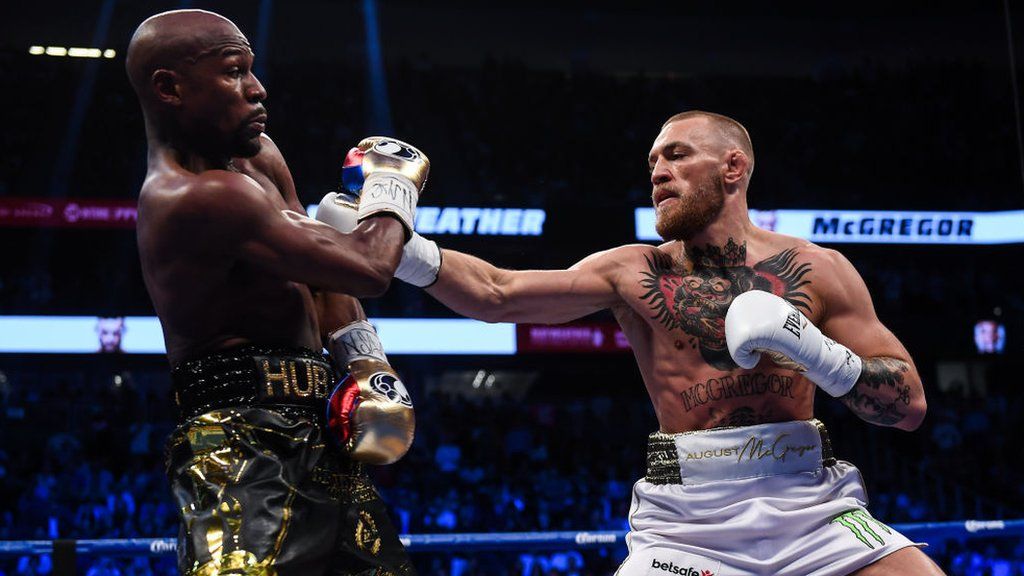 Floyd Mayweather dodges a punch from Conor McGregor
