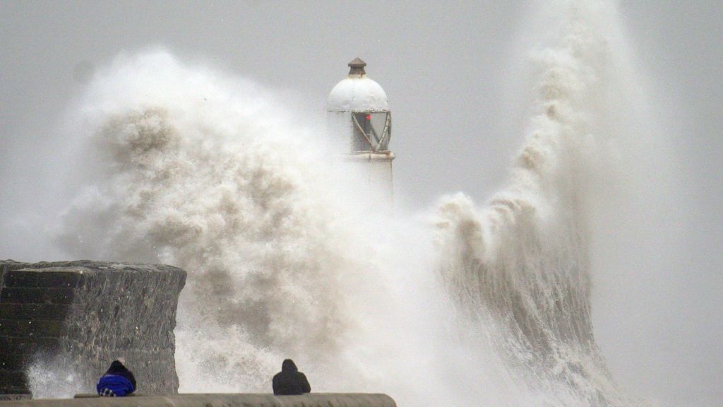 Waves crash over the seafront at Porthcrawl in Wales