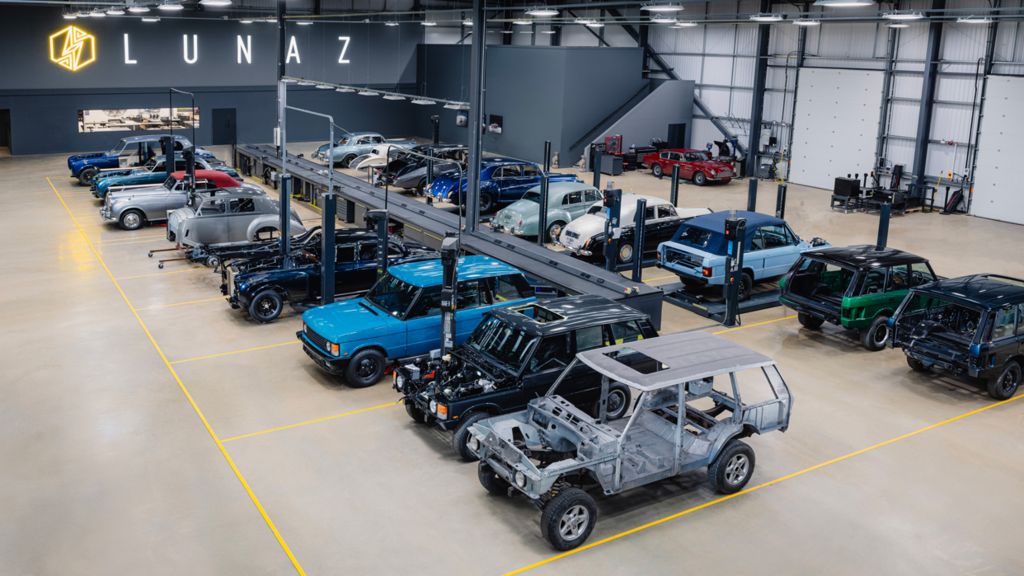 Car chassis from different brands lined up in a factory