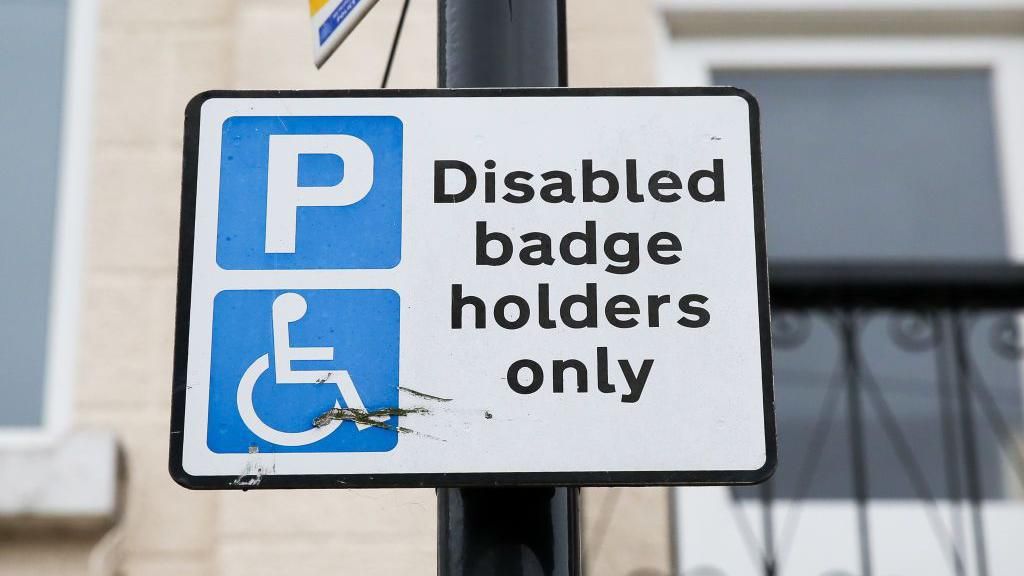 Disabled badge holders only parking sign