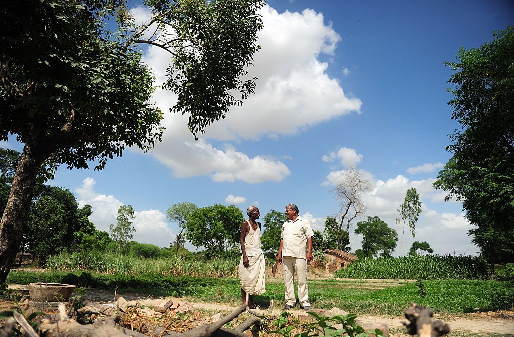 Lal Bihari Mritak (right) in 2015, meeting a farmer declared dead by his brother