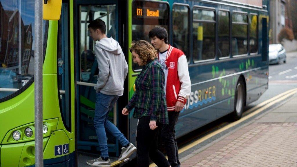 Young people boarding a bus