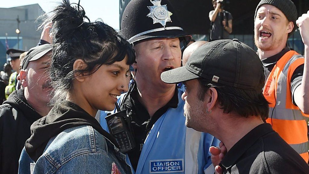 Saffiyah Khan smiling at an EDL protester