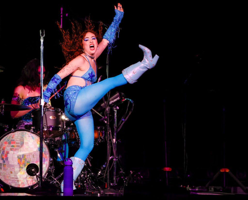 Chappell Roan does a high-kick while playing a concert in Boston, 2023