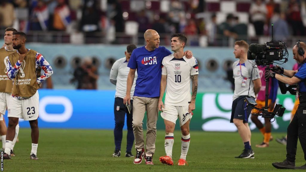 Gregg Berhalter puts his arm around Christian Pulisic after the United States' World Cup exit