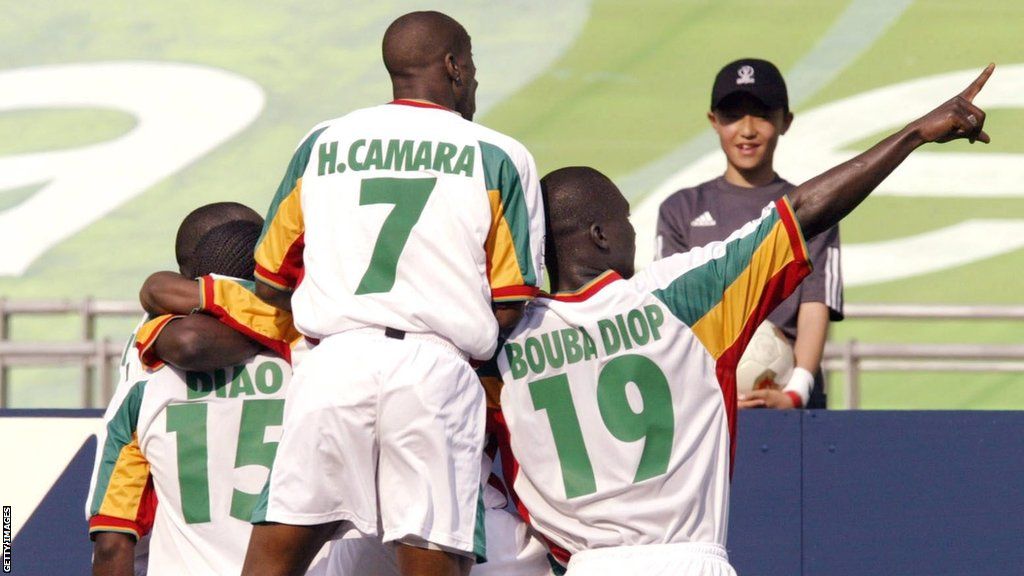 Salif Diao (left), Henri Camara (centre) and Papa Bouba Diop celebrate a goal at the 2002 World Cup