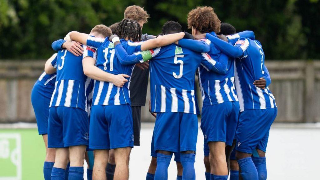 Thatcham Town players in a huddle at a match