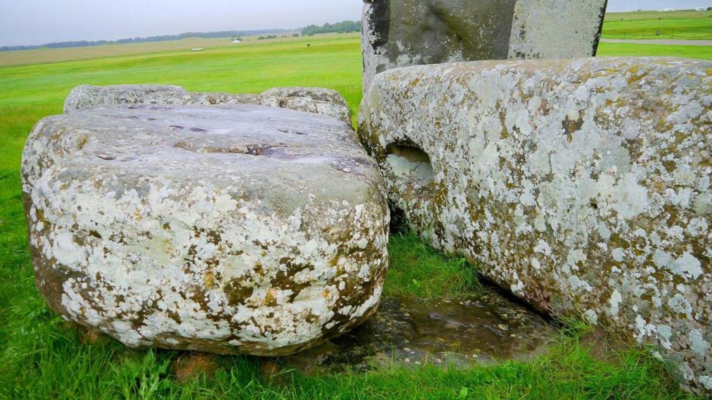 Two big stones which are part of the Stonehenge monument lie flat on the ground