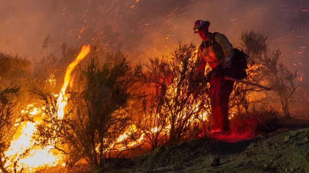 A firefighter battles the Sites fire near Lodoga, California, US, on Monday evening