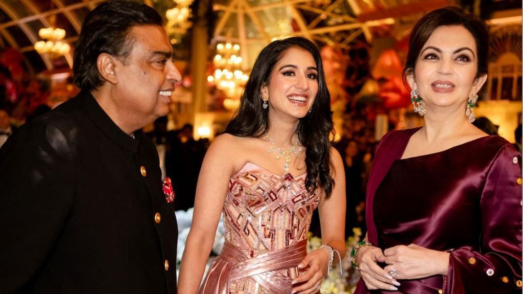 Mukesh Ambani, the chairman of Reliance Industries, Radhika Merchant and Nita Ambani, share a moment during the pre-wedding celebrations