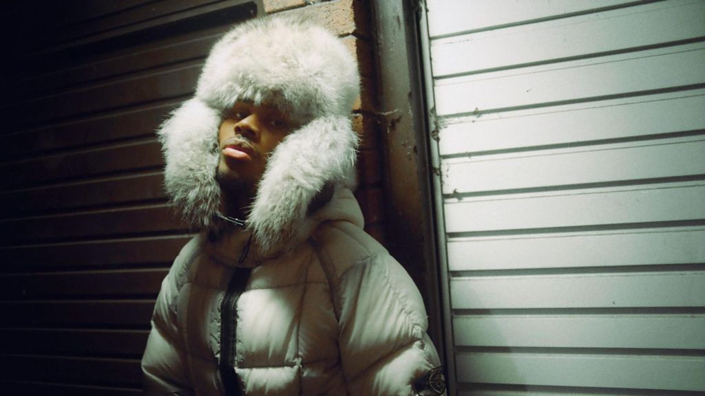 Jim Legxacy in a white padded coat