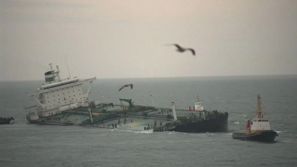 The Sea Empress pictured listing to side, with tug boats on either side