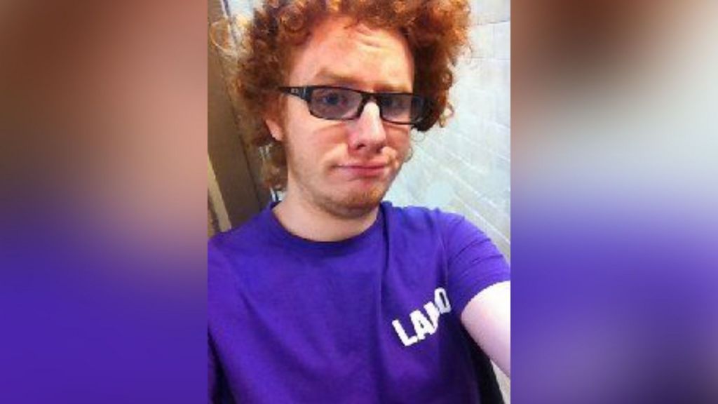 A 'selfie' of Bubb, who has longer, curly red hair than in his custody photo. He wears sunglasses and a purple T-shirt.