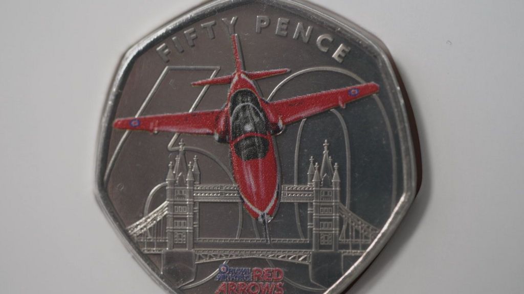 Fifty pence coin featuring a Red Arrow with Tower Bridge in the background a 60 outline