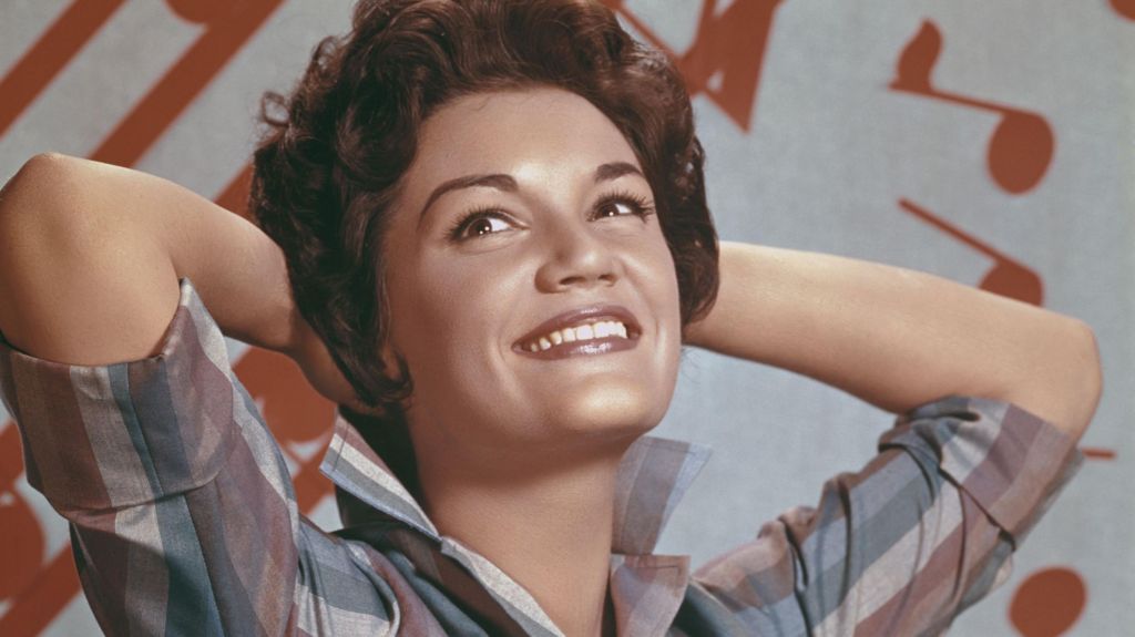 Connie Francis, pictured in the 1960s, smiles while posing with her hands behind her head