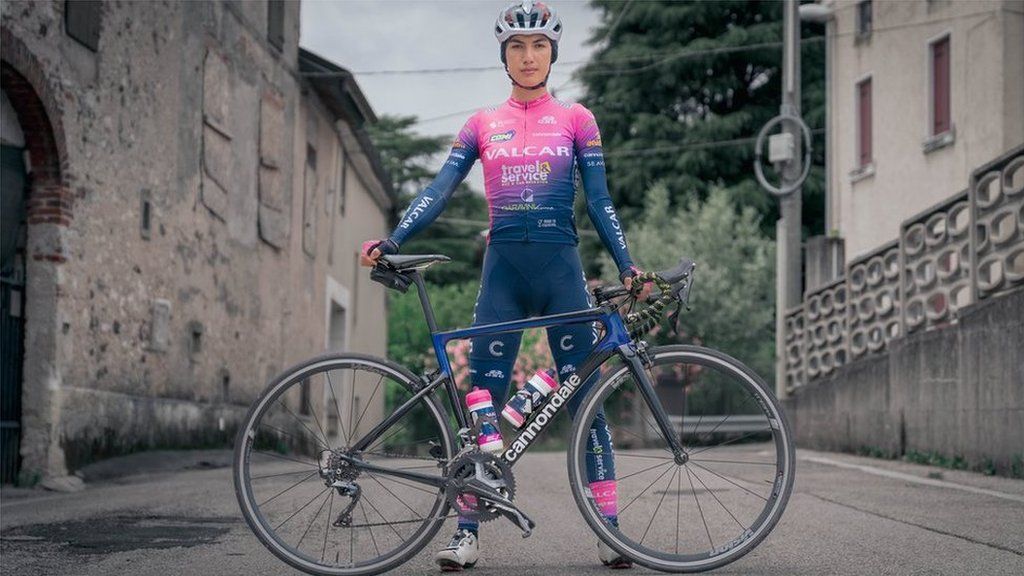 Fariba standing with her bike