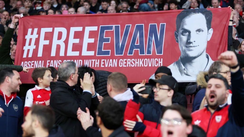 Arsenal fans hold a banner calling for Gershkovich's release at a 2023 game