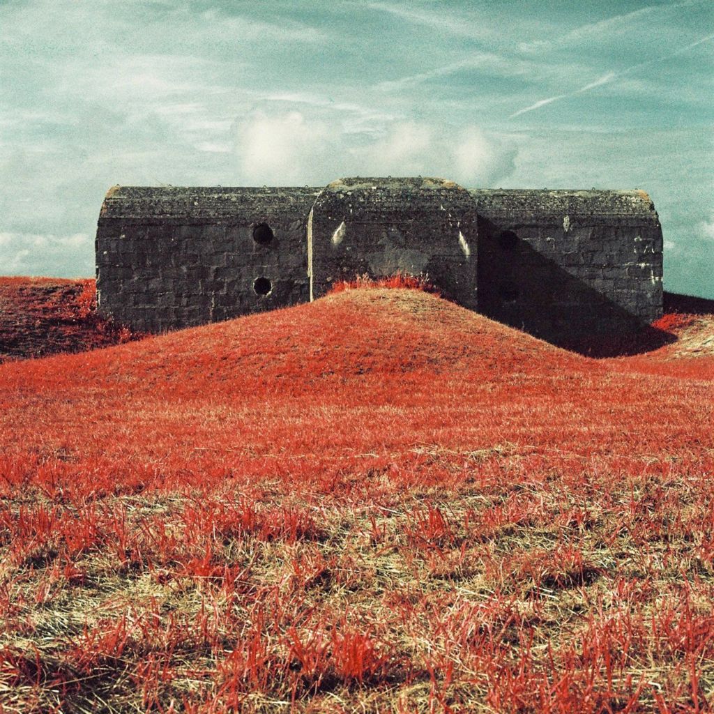 Infrared photograph of a bunker, surrounded by grass