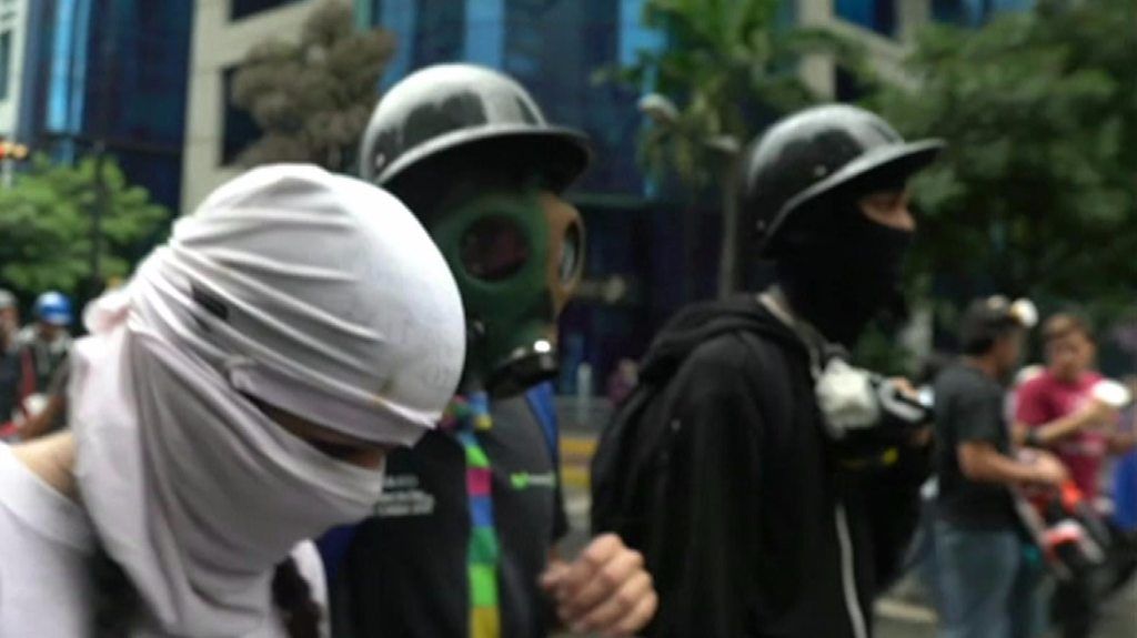 'Resistance' members in balaclavas and gasmasks