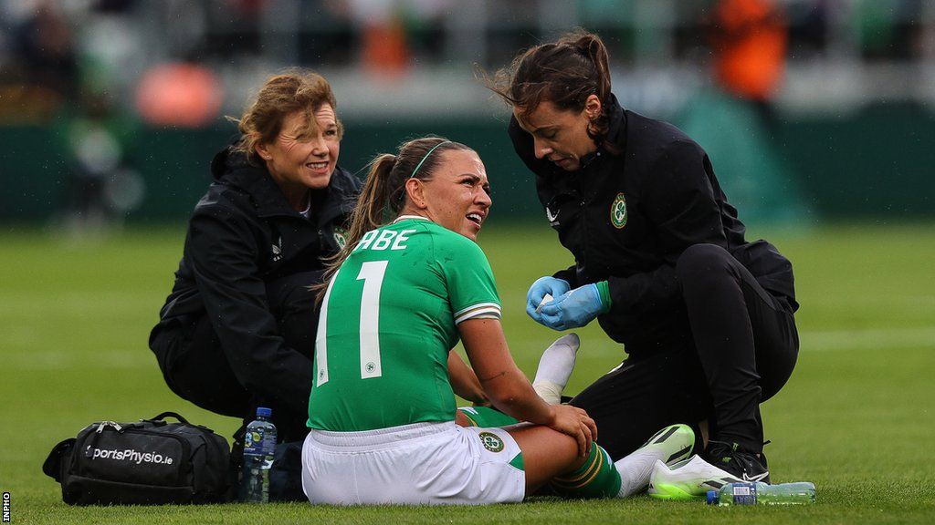 Katie McCabe receives treatment on the pitch