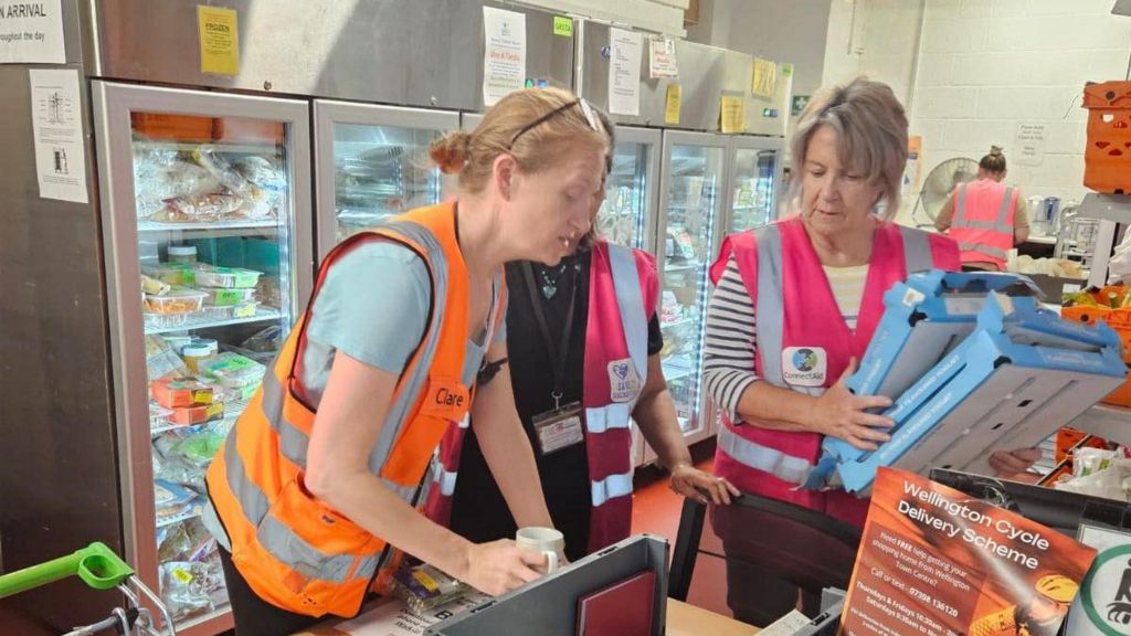 Foodbank volunteers sorting food in a warehouse