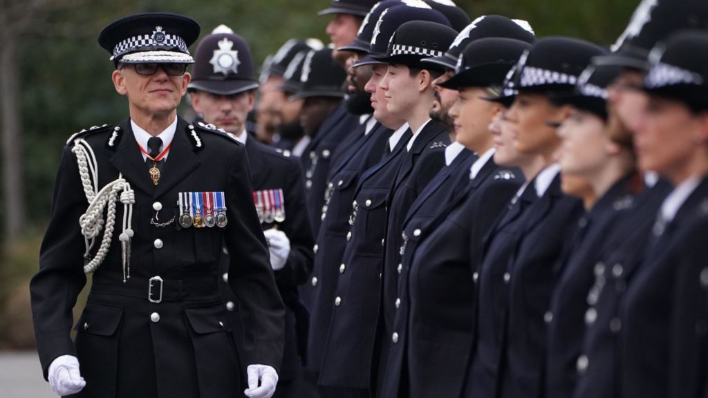 Metropolitan Police Commissioner Mark Rowley inspects new police recruits during his first passing-out parade
