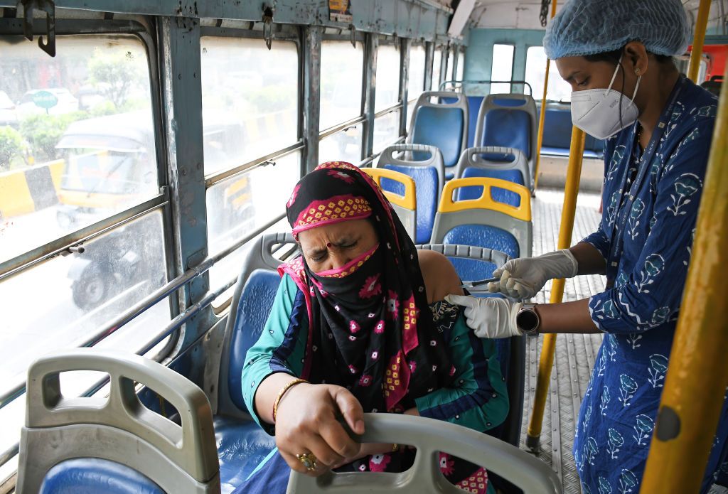 A health worker administers Covid vaccine to a woman in a bus in Maharashtra