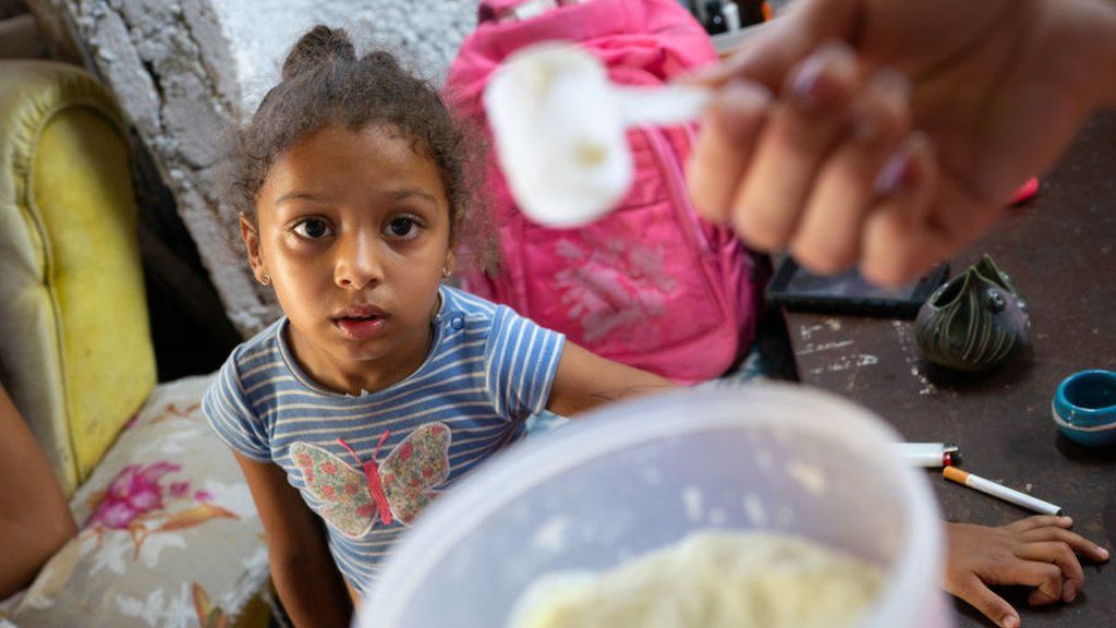 HAVANA, LA HABANA - APRIL 16: Laurent Alemany, 4, looks lovingly at the small amount of milk her mother,