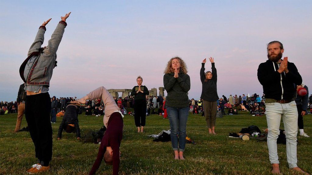 People doing Yoga at Stonehenge