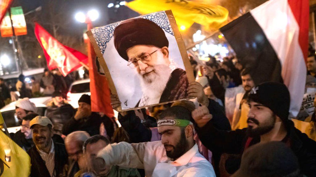 Iranian protesters hold up portrait of Supreme Leader Ayatollah Ali Khamenei and Yemeni flag