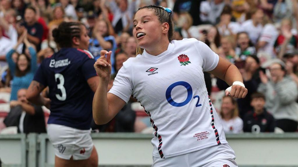 Jess Breach celebrates after scoring a try against France