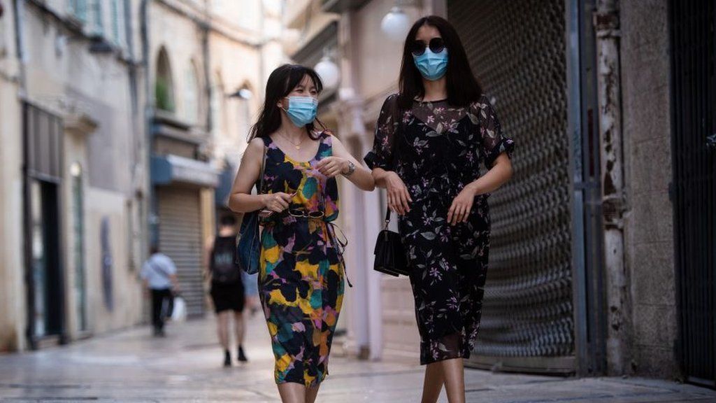French women walking down the street wearing face masks in Avignon, July 2020