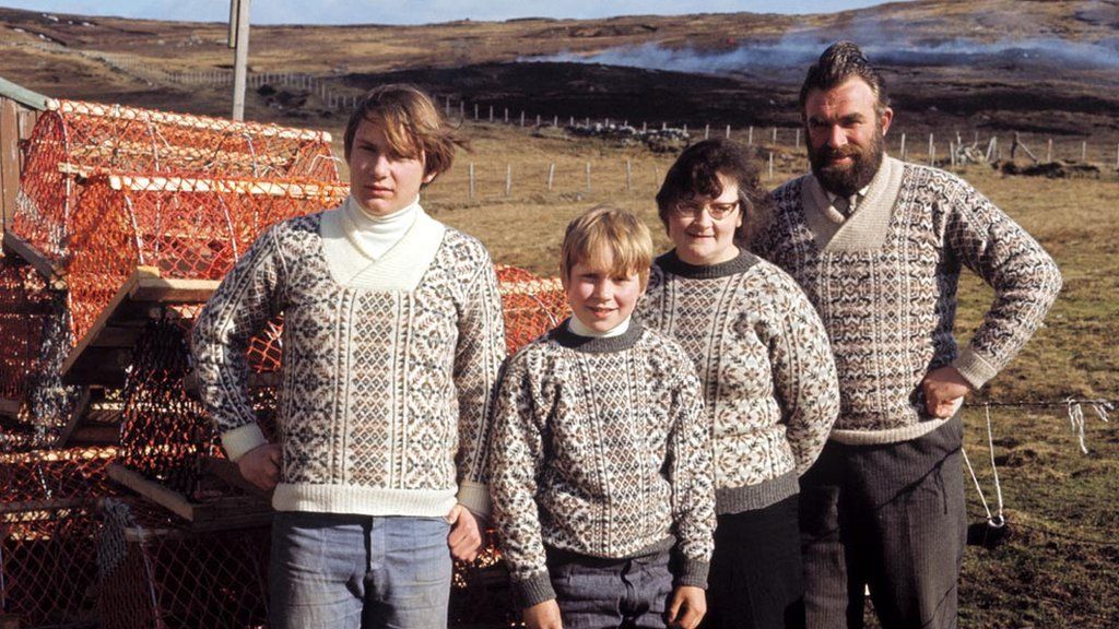 A family of Shetlanders pose wearing Fair Isle jumpers in front of lobster pots on one of the Shetland Islands in 1970.
