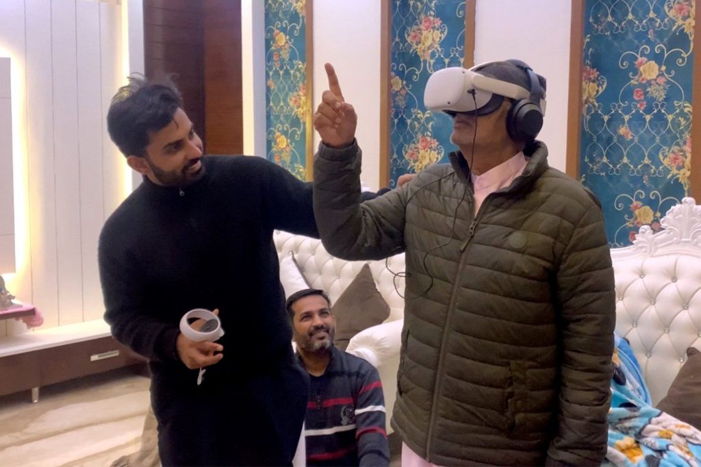 Ishar seeing his childhood village through Virtual Reality goggles